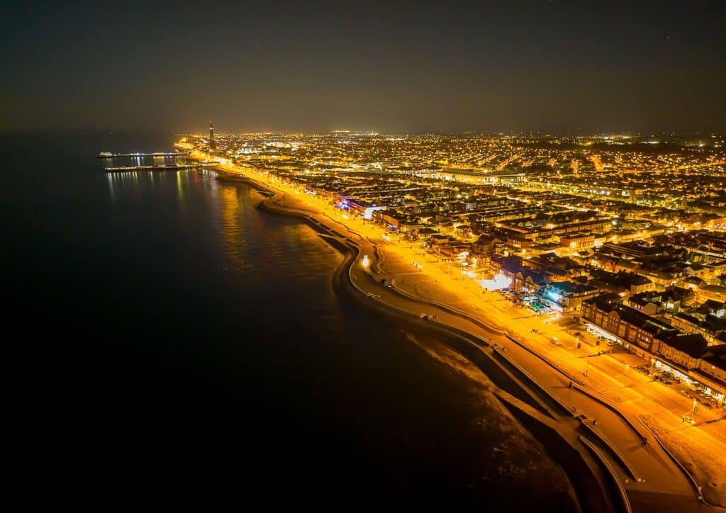 Aerial shot of Blackpool town illuminated with lights at night in England